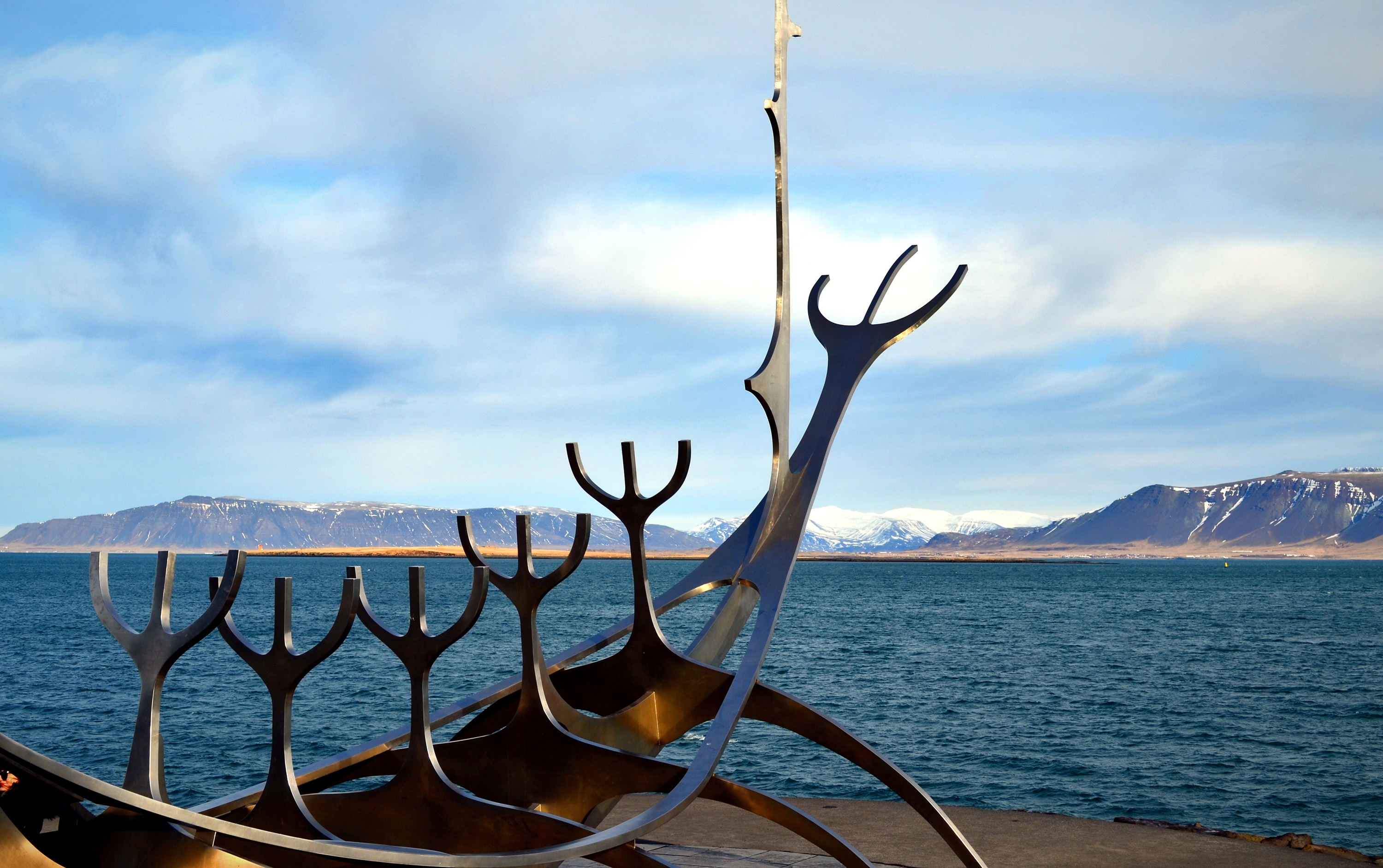 Reykjavik, snow-capped mountains above Faxaflói Bay and The Sun Voyager Solfar, Iceland